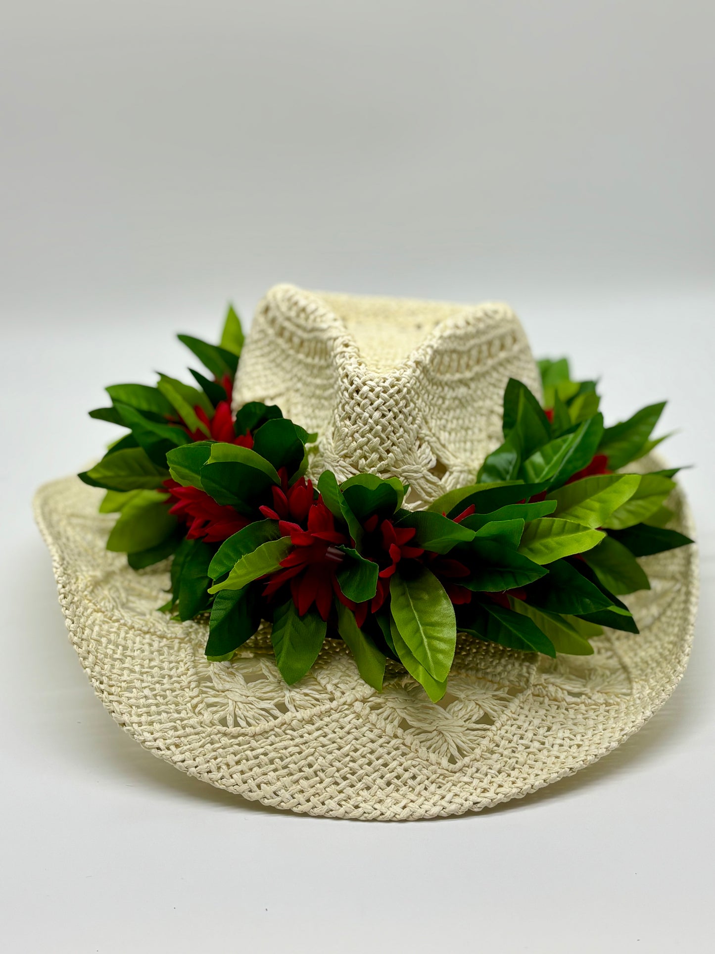 Maile Forever Lei Po‘o gracefully draped over a straw cowboy hat