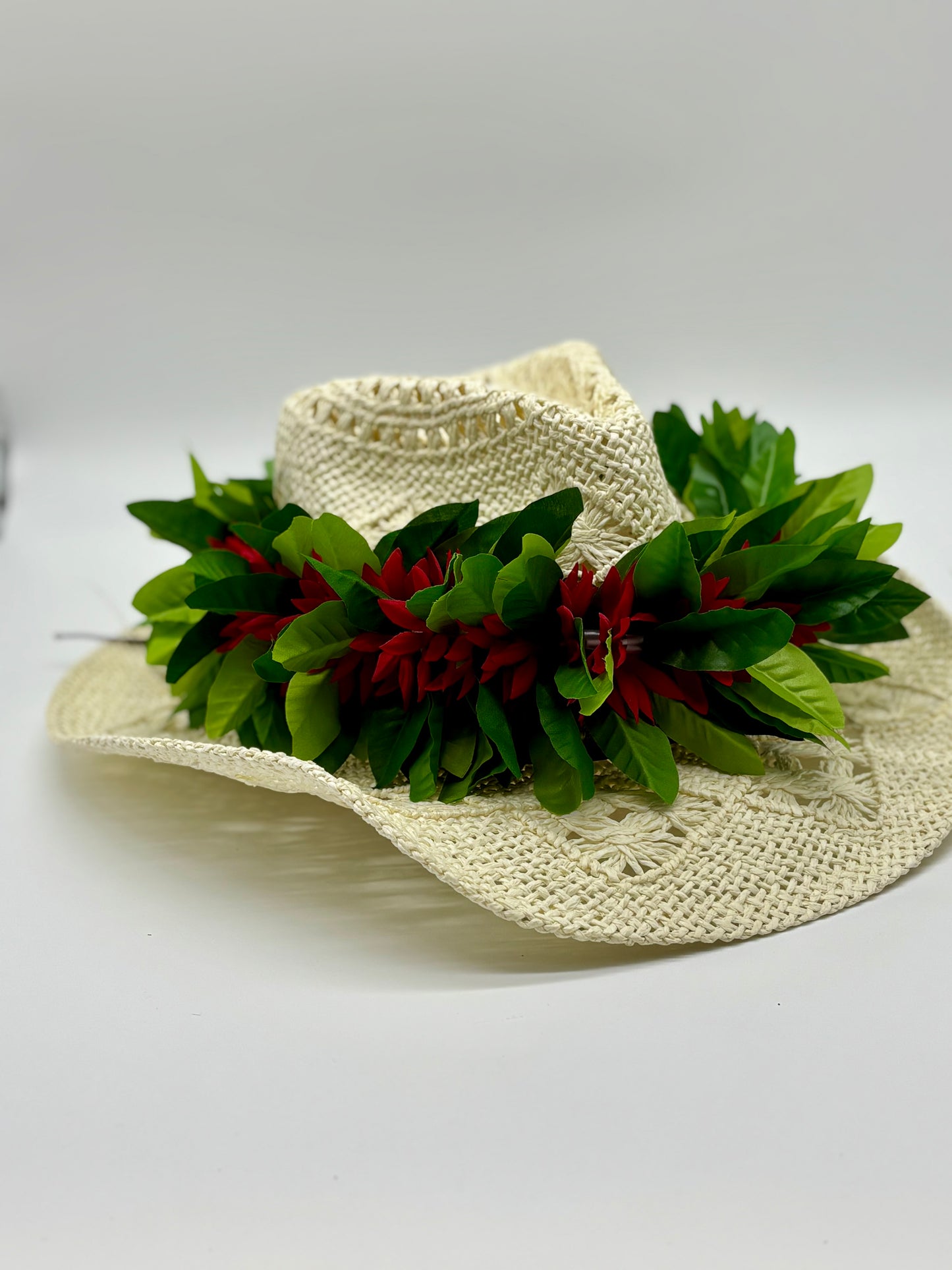 Maile Forever Lei Po‘o gracefully draped over a straw cowboy hat
