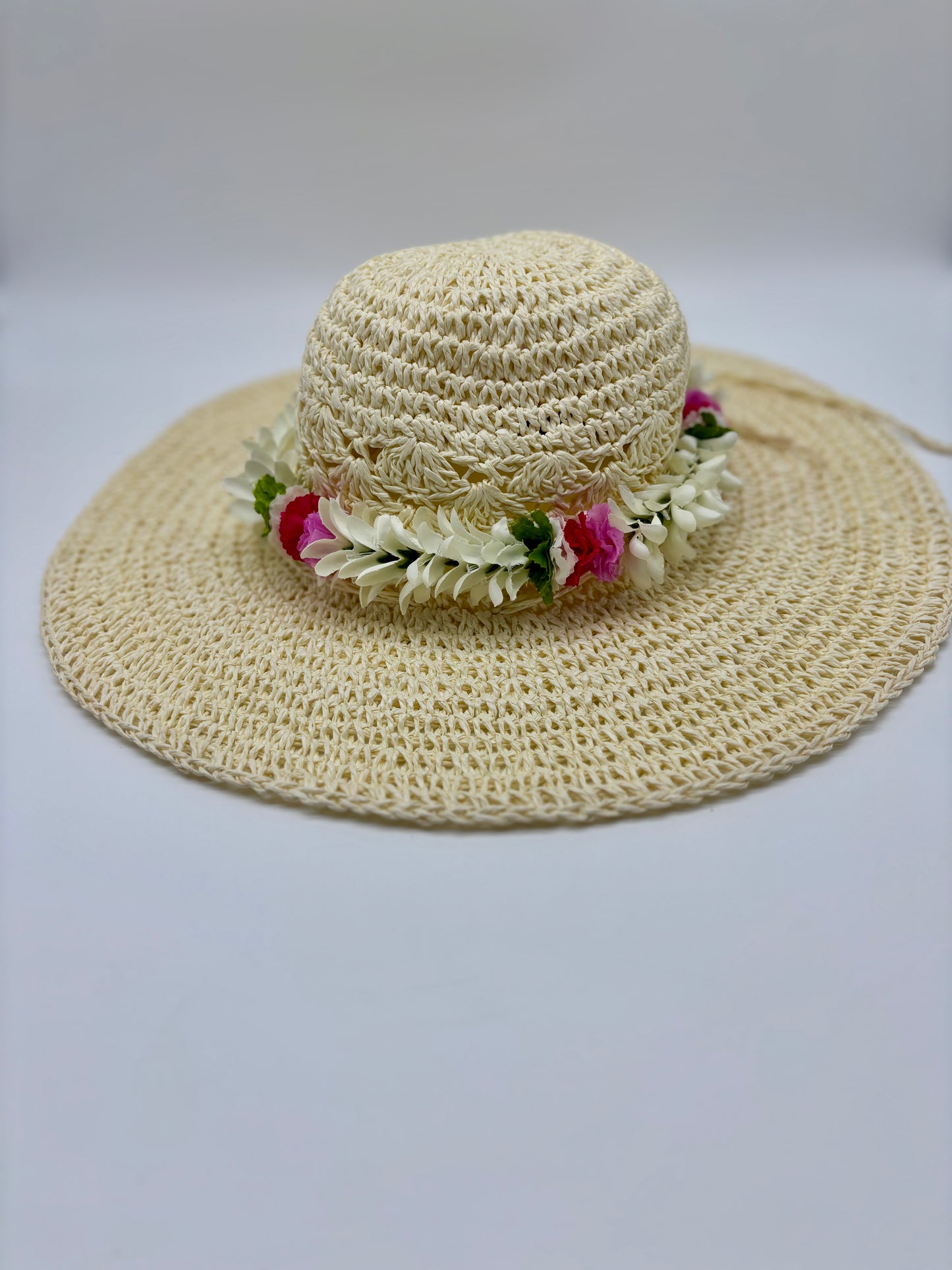 Tuberose Forever Lei Po‘o gracefully draped over a straw sun hat